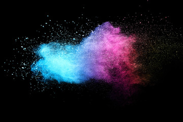 Explosion of colored powder isolated on black background. 