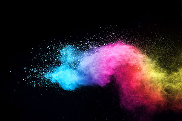 Fototapeta premium Explosion of colored powder isolated on black background. 