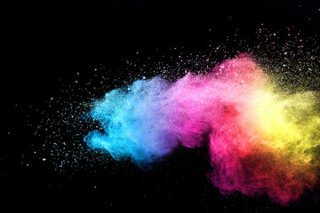 Explosion of colored powder isolated on black background. 