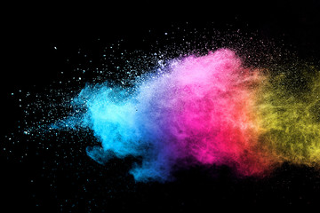 Explosion of colored powder isolated on black background. 