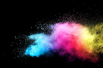 Explosion of colored powder isolated on black background. 