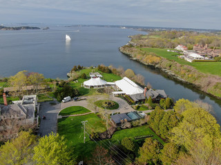 Aerial view of wedding reception ceremony setup with big white tents next the sea in Castle Hill...