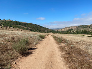 Fototapeta na wymiar Dry dusty trails in the valley with blue sky, San Diego, California, USA