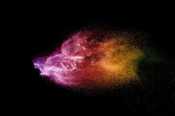 Explosion of colored powder isolated on black background. 