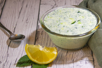 The sauce consists of kefir, green cucumber and lemon. A dish of Iranian cuisine. Snack with chips.