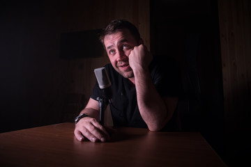 Serious reporter in television studio looking at the camera