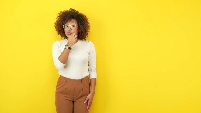 Young african american woman keeping a secret or asking for silence