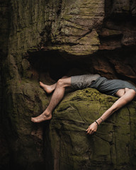 Climber pausing on a rock while climbing a mountain.