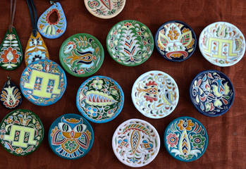 Traditional Crimean Tartar ceramics, painting: plates, saucers and pendats placed on tablecloth