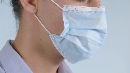 Close-up portrait of a man wearing a safety surgical face mask.  Safe way to avoid getting infected.