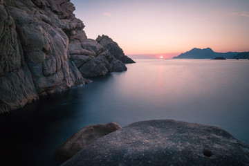 Tranquil scene during sunset with rocks in the foreground  in Marine de Porto, Corsica, France