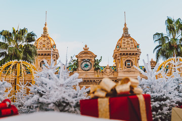 Obraz premium Monte Carlo Casino in Monaco, 25.12.2019 Cote de Azur, Europe. View of Grand Theatre, office of Les Ballets de Monte Carlo in winter. white Christmas tree, red gift boxes and New Year decorations.