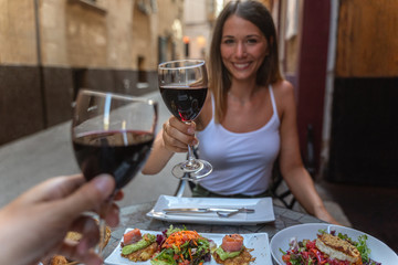 a couple celebrating anniversary with a glass of wine and delicious dinner