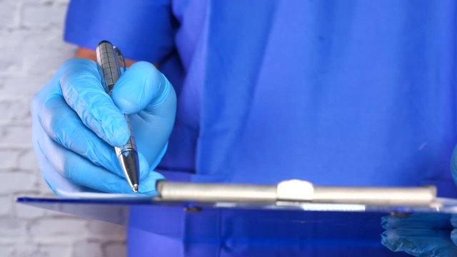 doctor hand in protective gloves writing prescription, 
