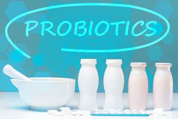 Logo probiotics on biologist desk. Plate for grinding tablets. Bottles filling with probiotics....