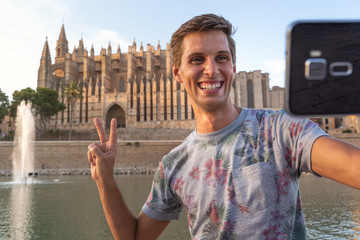 A man taking selfie in front of cathedral © NDStock