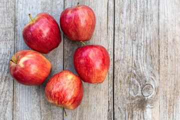 Red apples on a wooden background. Copy space.
