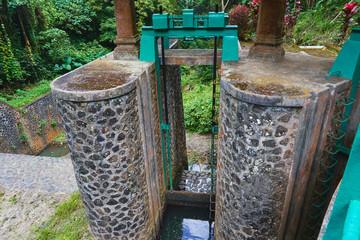 Photo of an old water dam for water supply to rice fields with water tap