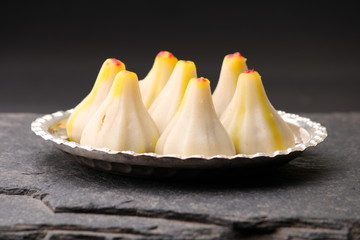 Steamed Modak, made from rice flour and coconut jaggery filling. Modak is a traditional Indian sweet made during Ganesh Utsav and also offered to lord Ganesha