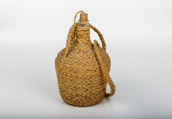 Old-style wine jug on the white background