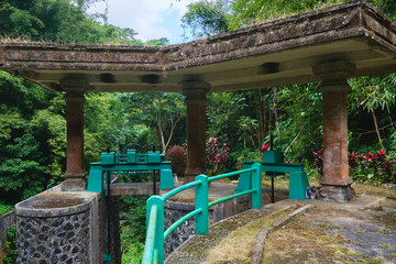Fototapeta premium Photo of an old water dam for water supply to rice fields under a stone roof