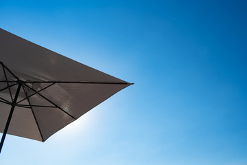 bottom view. beach umbrella against blue sky.