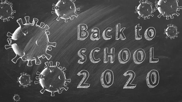 Hand drawing and animated text "Back to School 2020" on blackboard. Covid-19 concept. Start of the new school year 2020