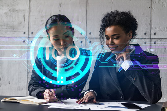 Two businesswomen work together in modern office on new project. Double exposure. Concept of success. ICO icon.