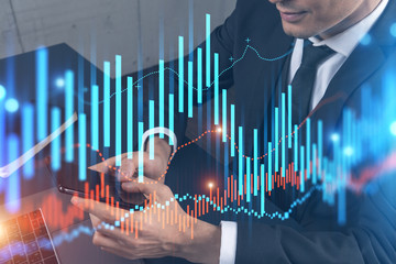 Trader in office working with Smartphone, FOREX graph hologram to analyze market behavior, typing phone. Double exposure.