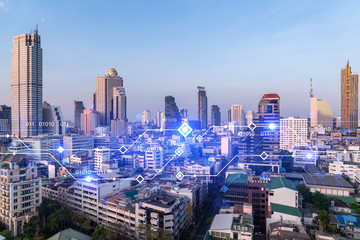 Technology hologram over panorama city view of Bangkok. The largest tech hub in Asia. The concept of developing coding and high-tech science. Double exposure.