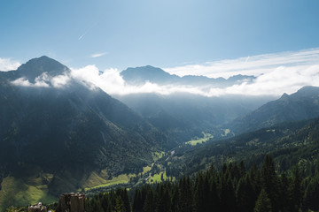 Bavarian Landscape in the near from Oberstdorf in the morning with clouds and trees.
