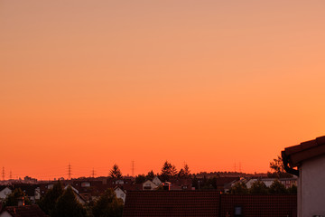 Blood red sky over the roofs of a village