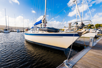 Sailboats moored to a pier in Rhu marina. Firth of Clyde, Scotland, UK. White yacht close-up....