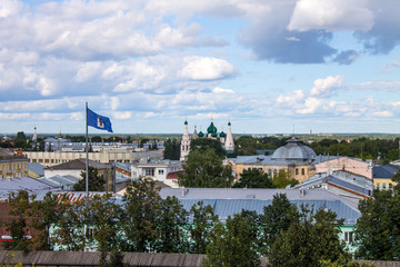 panoramic view of the old city with historical architecture against a blue sky with white clouds on...
