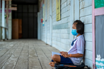 Elementary school students wearing disease prevention masks,Child with face mask going back to school after covid-19 quarantine and lockdown.