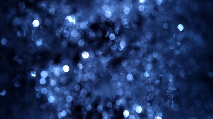 Full frame defocused and Bokeh snow and tinsel glow. Festive blue and white gala glitter abstract...