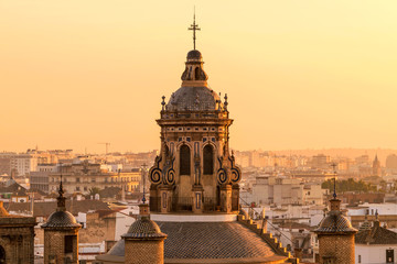 Sunset Seville - A close-up golden sunset view of the dome and bell tower at top of the 16th-century Renaissance style Iglesia de la Anunciación - The Annunciation Church in Seville, Andalusia, Spain.