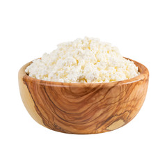 Fresh cottage cheese in a wooden bowl isolated on a white background.