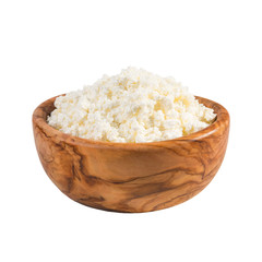 Fresh cottage cheese in a wooden bowl isolated on a white background.