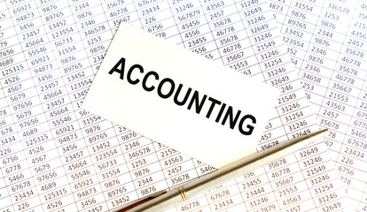 Obraz premium Finance and business concept. The businessman has on his desk graphs with reports, a notebook, a magnifying glass and a document with the inscription - ACCOUNTING
