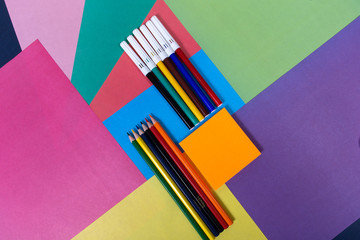 pencils and flares on a multi-colored background