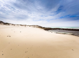 Blue cloudy sky and yellow sand on the coast in De Hoop Nature Reserve in South Africa
