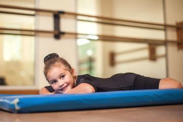 Kid at gymnastic class doing exercises. Children and sport concept