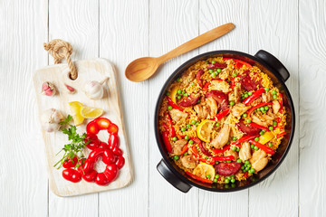 spanish chicken paella in a black dish