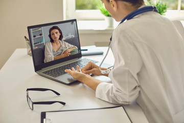 Telemedicine or telehealth concept.A young woman doctor in her office gives an online consultation.