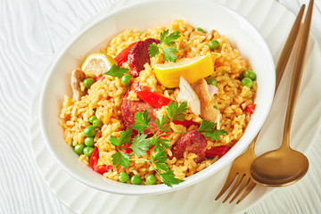 spanish chicken paella on a white plate