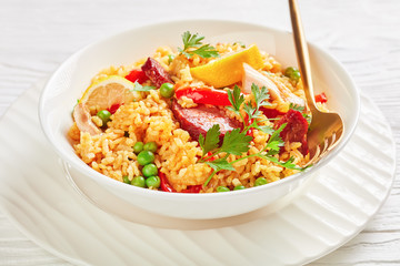 spanish chicken paella on a white plate