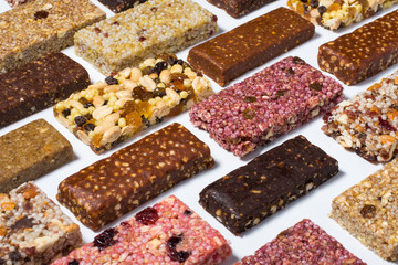 Composition with cereal granola and protein bars with nuts and dry fruit berries on the white...