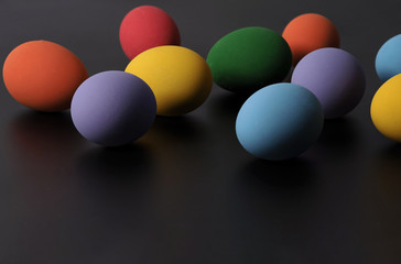 Multi-colorful of easter eggs on background in studio with close-up shot which include many colour such as yellow, green, blue, purple, red covered on eggs by art painting