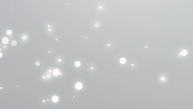 White glowing particles floating slowly in the air